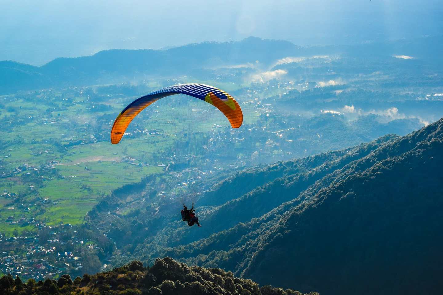Paraglider over the Bir valley below Billing
