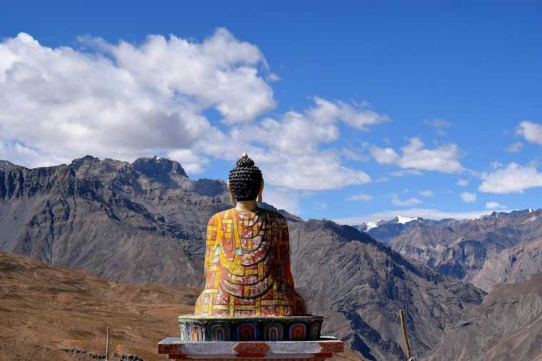 Buddha statue facing the mountains of the Spiti valley
